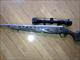 MOSSBERG 4X4 338 MAG SCOPED, MUZZLE BRAKE FLUTED LAMINATED