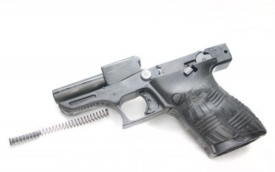 The steel barrel is pinned to the polymer frame and does not move when the gun fires.