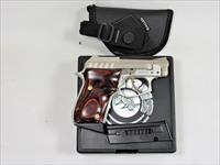 299BB TAURUS PT 22 STAINLESS WITH GOLD ACCENTS.
