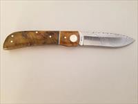 M. NIETO Spanish handmade folding knife.  Handle is Curly Birchwood.  14C28N Stainless Steel blade with a delicate hand engraved pattern. Bolster is Deer Bone.  NO.1  OF  1 OF A LIMITED EDITION.  N8.  *MSRP: $399.99*