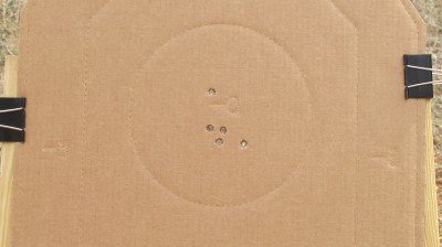 The first five rounds through the pistol at approximately 10 yards showed promise. The high flier was the first double action shot and the quad cluster were the follow up single action shots.
