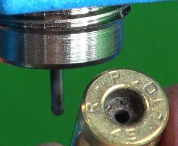 An Introduction to Reloading for Handguns The first die resizes the case and "decaps" it by poking out the old primer with a hard rod.