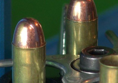 After seating the bullet (left) the case mouth is crimped shut (right) to hold the bullet firmly in place.
