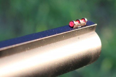 The front sight on the A5 is a bright red fiber optic. It sits on top of a long flat rail that extends all the way to the back of the receiver. 