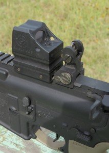 The compact aluminum housing of the CQS is no wider than the backup iron sights mounted on this AR15.