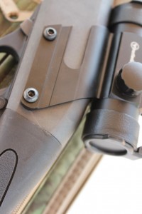 The optic mounts with screws through the holes for the pins holding the fire control system.