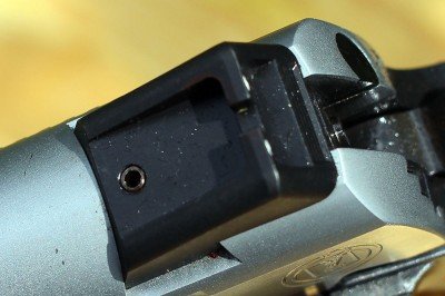 The rear sight is adjustable. The dots are not as bright as some, but they work well.