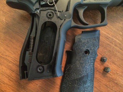 Two-piece grips are attached with two flathead screws per side.