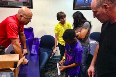 Using replica firearms, the deputy trainer shows children how to safely hold a firearm. (Photo: Sun-Sentinel)