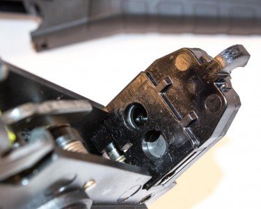 Beretta's ARX100: A Closer Look The two holes shield the crossbar which activates one extractor while stopping the other.