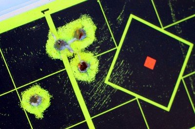 Accuracy with the laser is close enough. At 7 yards, this shooter put 5 rounds within two inches of point of aim.