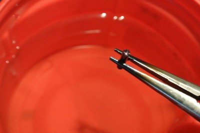 Out of the quench tank.  If you use pliers to hold the parts you also end up bluing them too.  Bonus.