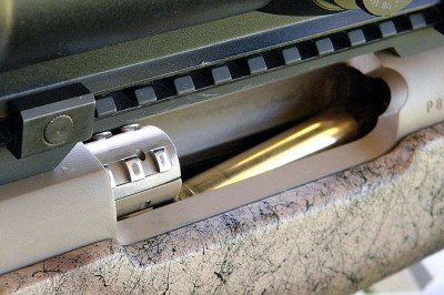 The Mark V is a push feed rifle. You can see the bolt picking up the top round from the magazine as it travels forward.