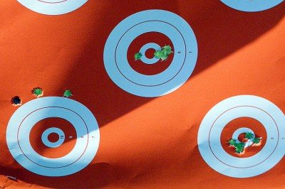Zeroing target. With the center bull as point of aim, the first 3 rounds impacted just above the lower left target. After making a scope adjustment, the next 5 rounds grouped close to the center. A final adjustment produced the group at the lower right. If I was zeroing for a hunt, I would have fired another group to confirm the zero. Considering this was simply for evaluation, plus the rounds cost $3 each, I went with this zero.
