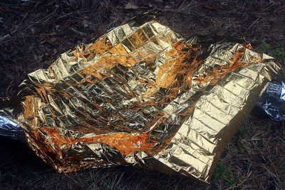 The space blanket will keep you warm, but it is crinkly and loud. 