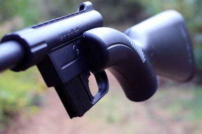 The left side of the gun protrudes out. This is where the barrel sits when compacted.