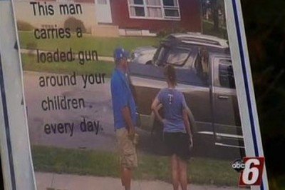 Here's a image of the sign, which has a caption, "This man carries a loaded gun around your children every day." (Photo KAAL-TV)
