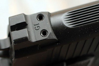 The shelf on the back of the front of the rear sight allows for one handed manipulation--simply catch the ridge on a holster or boot heel and rack the slide.