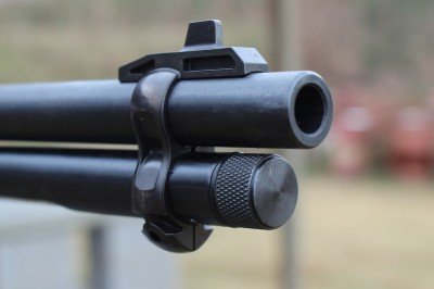 The front sight on the earlier version was built into a barrel band. 