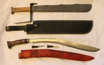 These are the two short swords mentioned in the article. The top one is 3 lbs. and has that giant hand guard, which is itself a hammering weapon. The bottom is my long Kukri, and not my first choice in a hand to hand combat weapon. 