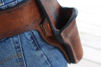 Note the leather block behind the holster to push the grip out from the hip.