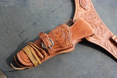 The tooling on the blet matches the tooling on the holsters. 