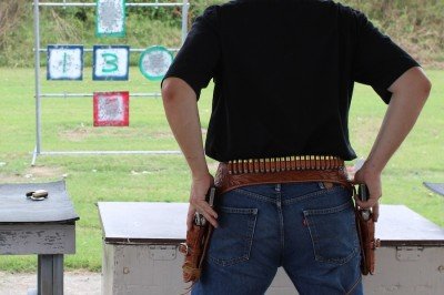 Drawing both guns at once is easy. Shooting both single actions at once is not.