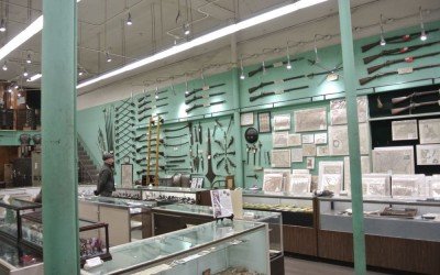Guns on the walls, coins in the cases. They sell antique maps too.
