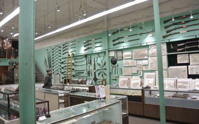 Selling History-Cohen and Sons of New Orleans Guns on the walls, coins in the cases. They sell antique maps too.