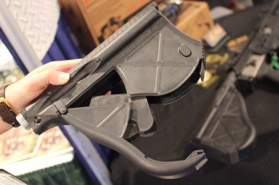 Empty and open.  The tube on top of the stock can hold batteries. 