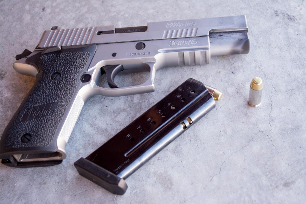 That cartridge is too short to be a .40 S&W! It's the new Sig P220 chambered in 10mm.