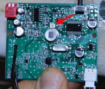 By removing two screws you can get at the board, and dab a bit of liquid electrical tape over that confounded green LED, shown here.