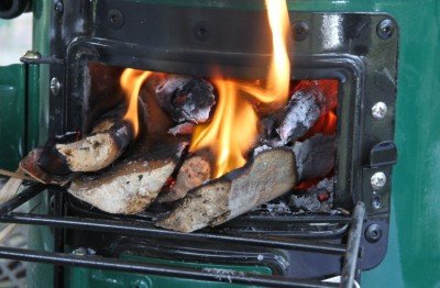 After the chicken there was still this much fuel left, so I jammed it in and closed the fuel door to see how long it would burn. It kept the water pot boiling more than a half hour longer. 