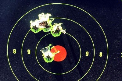 100 yards, top group is one 4 shot group from bipod. Bottom group is 2 shot group after sight adjustment.