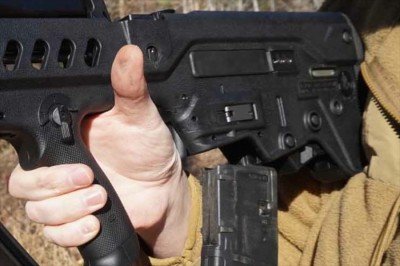 Israel Defense Forces IWI Tavor Review Mags drop free when the back of your hand hits this lever in front of the mag.