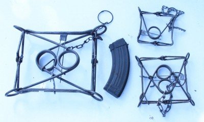 These are three sizes of Conibear, or "killer" traps, with their mainsprings folded in. The one of the left is the 330 size, and the 110 and 160 are on the right, with the AK mag in there for a size reference. 