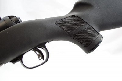 The synthetic stock pistol grip has aggressive checkering on both sides.