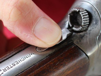 Push the button down and turn the knob to take the stock off the receiver. 