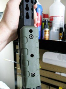 These holes allow the screws securing the forend to be loosened without taking off the plastic handgrip.  This is something that has been carried over from the PSR and AXMC rifles. 