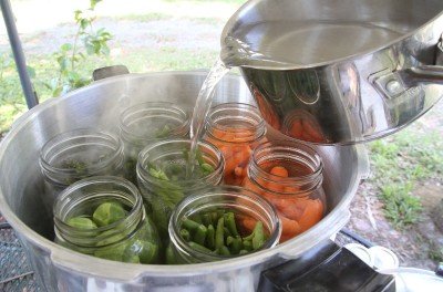 For this article I chose cold pack for veggies. The upside is that you don't have to handle hot glass jars, but you lose a lot of capacity per bottle that you can capture if you cook the veggies a little first. For cold pack you cover with boiling water, then stir to remove air bubbles before capping.