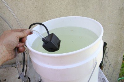 The water runs to an electric pump. For survival, this type of still is probably not as good as a coil type, but if you have a solar system it certainly doesn't take that many watts to run the small fish tank pump. 