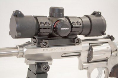 The included red dot optic offers red and green adjustable intensity dots.