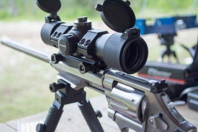 The iron sight is not in the way of the included red dot, but I had to remove it to mount a magnified scope.