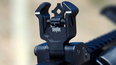 The Diamondhead flip-up rear sight has two peep-hole sizes and clear windage adjustment markings. 