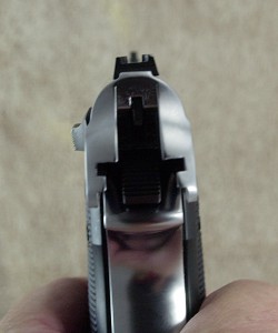 The .22 sight is a simple post up front with a U-shaped rear sight. The rear sight is flat enough to use as a one handed cocking assist on both guns.