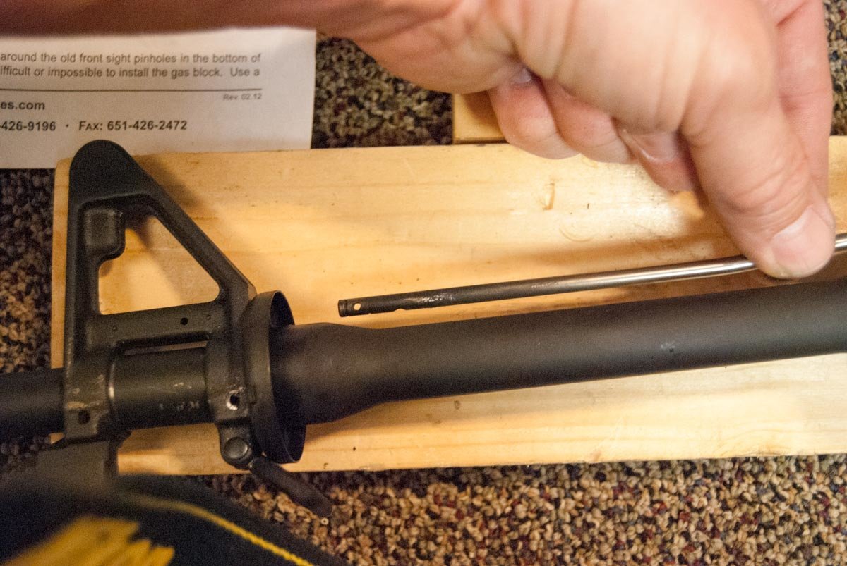 On a direct impingement AR-type rifle, the gas tube connects to the gas block and/or front sight and directs gas back to the bolt carrier group in the receiver.