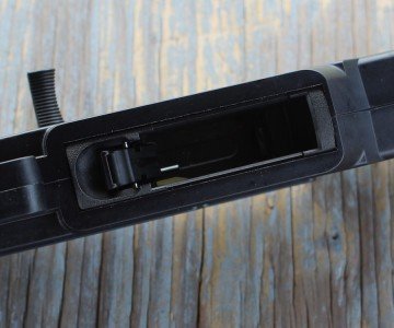 The mag-well is easy to find, and has a thumb latch for the release.