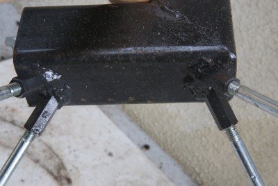 This stove has nifty welded on feet. Others have a crossbar on the back to hold them upright. 