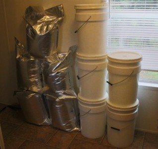 On the right are my 6 gallon buckets that I suggested in my first installment on food storage. By the pallet they are like 6 bucks each. The 20 x 30 Mylar bags next to them are about $1.50 each, and they hold more. As you can see, they don't stack as well though. 