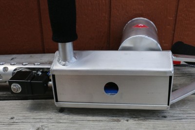 The battery compartment cover simply slips into the cavity and is held by gravity.